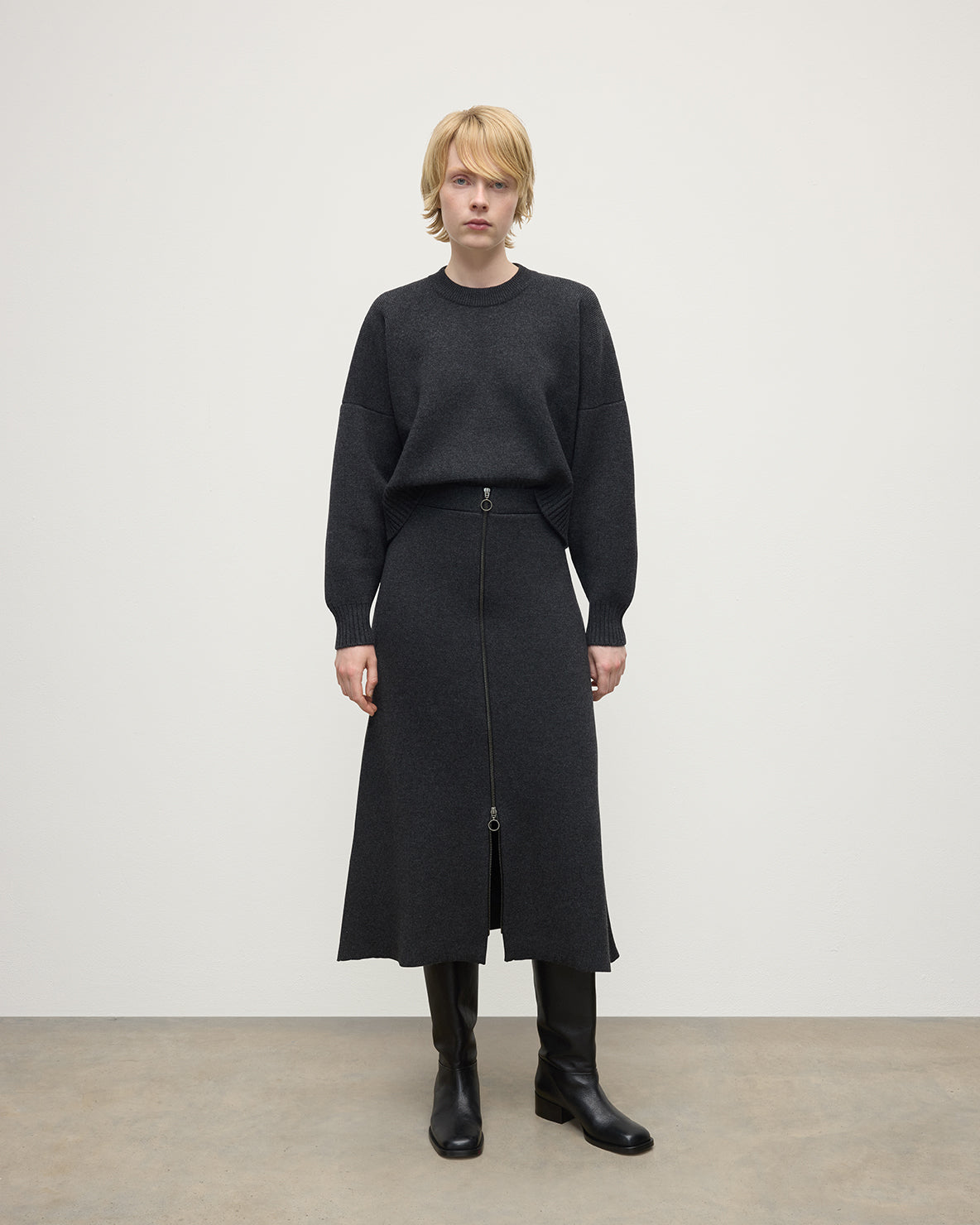 Model wearing Johnstons of Elgin AW25 Women's Knitwear Charcoal A-Line Milano Grey Cashmere Skirt Front View KAA05600HA7165