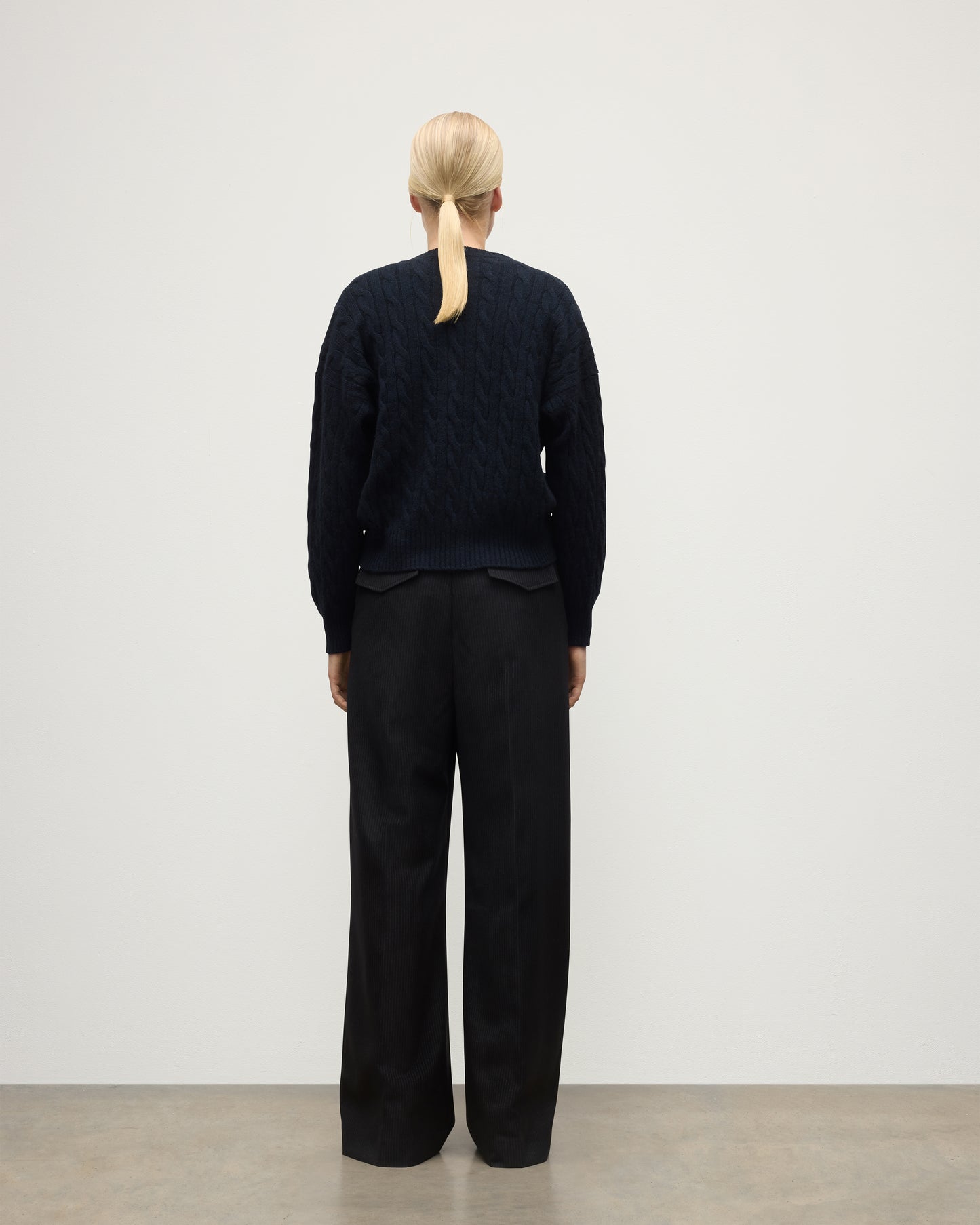 BACK OF WOMENS KYLESKU DEEP VEE SWEATER NAVY ON A MODEL KAA05728HD7347