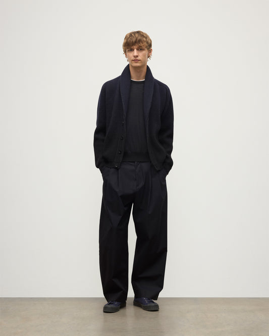 MALE MODEL WEARING JOHNSTONS OF ELGIN PIONEER SHAWL CARDIGAN NAVY & BLACK 100% CASHMERE WITH BLACK SUPERFINE CASHMERE SWEATER AND NAVY TROUSERS KAA05750Q25947