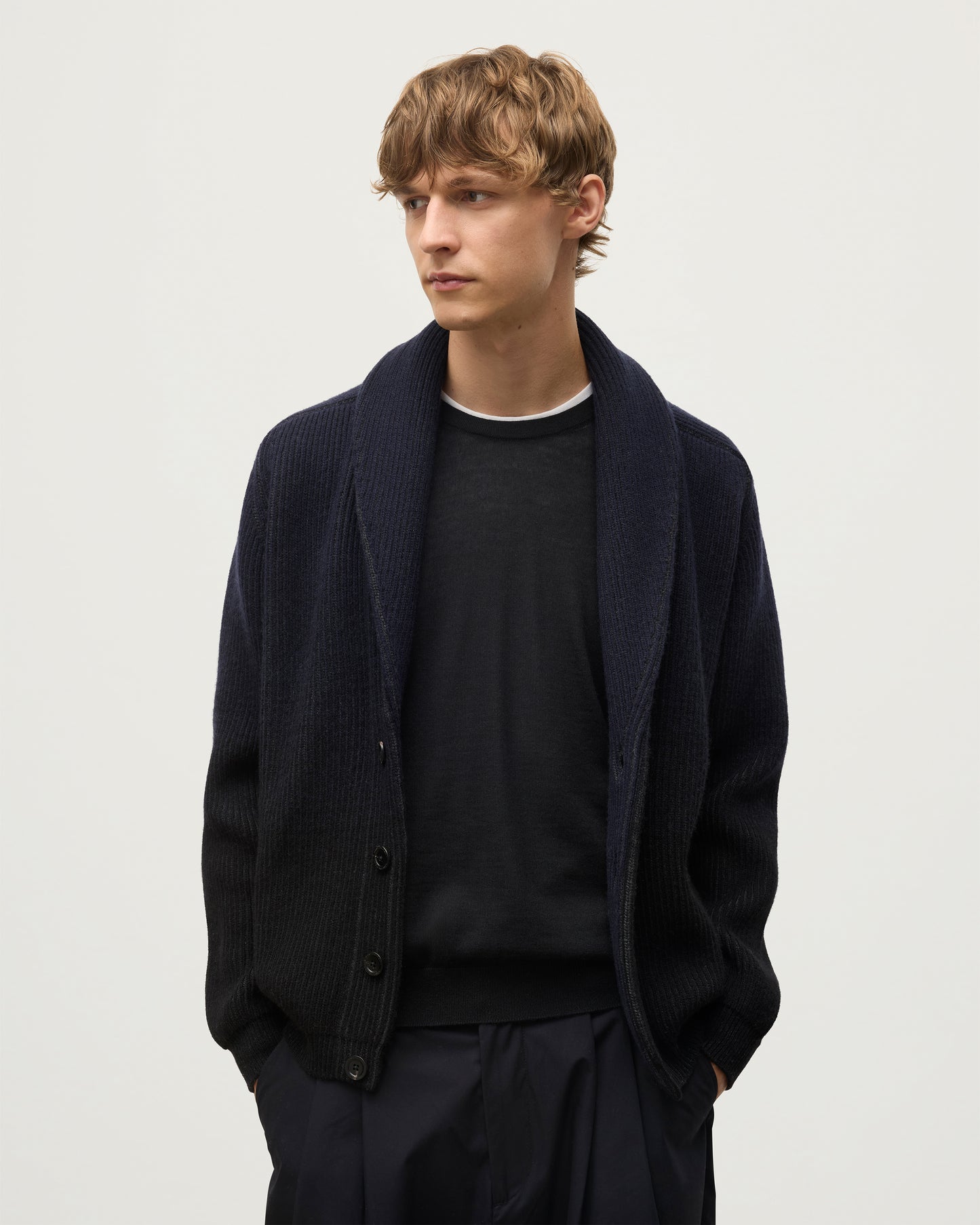 MALE MODEL WEARING JOHNSTONS OF ELGIN PIONEER SHAWL CARDIGAN NAVY & BLACK 100% CASHMERE WITH BLACK SUPERFINE CASHMERE SWEATER KAA05750Q25947