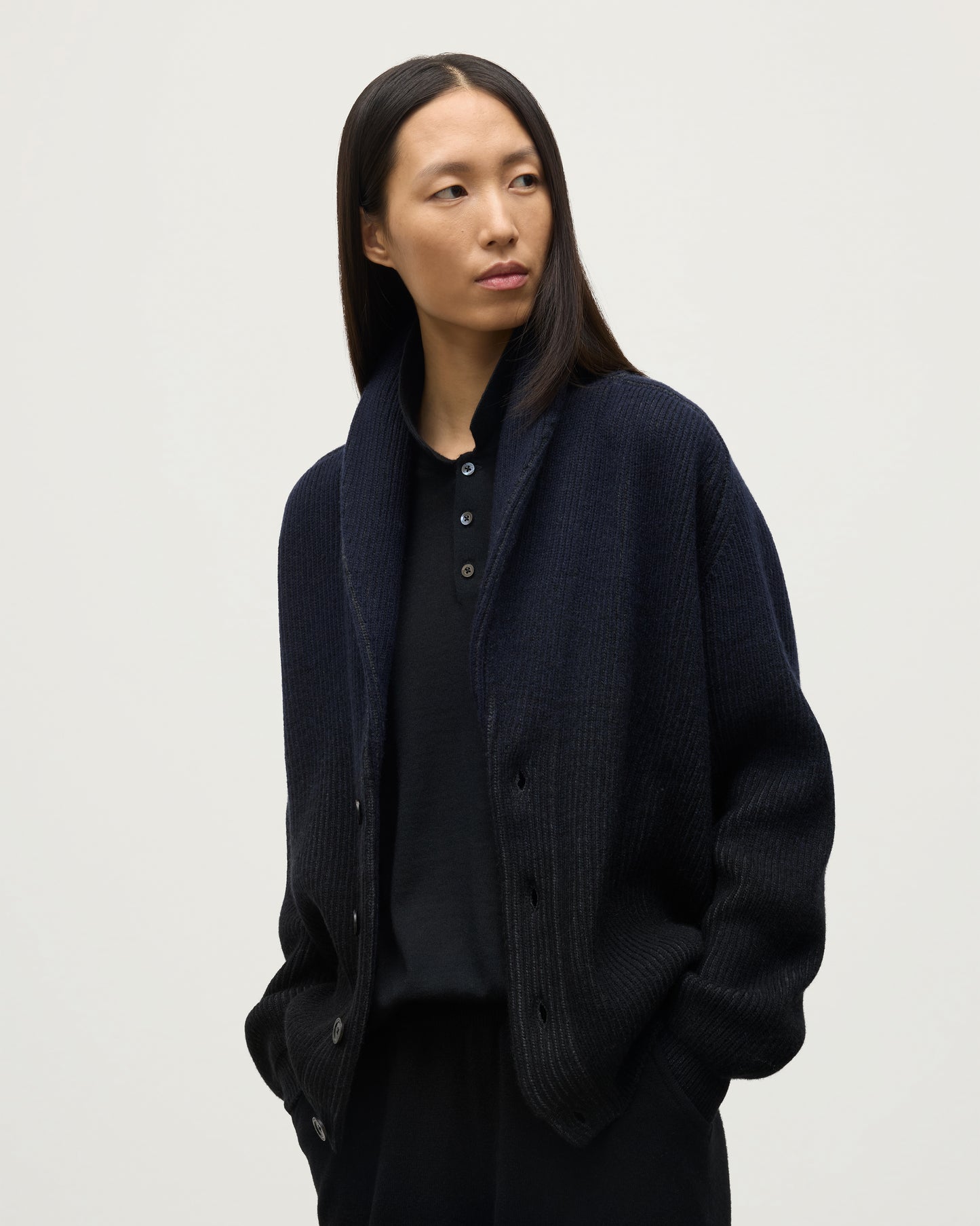 FEMALE MODEL WEARING JOHNSTONS OF ELGIN PIONEER SHAWL CARDIGAN NAVY & BLACK 100% CASHMERE WITH BLACK  POLO SHIRT UAA05750Q25947