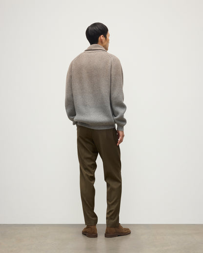 MALE MODEL WEARING JOHNSTONS OF ELGIN PIONEER SHAWL CARDIGAN GREY 100% CASHMERE WITH OLIVE GREEN CHINOS, OVER A SUPERFINE CASHMERE LIGHT BROWN SWEATER AND WHITE T-SHIRT KAA05750Q25948