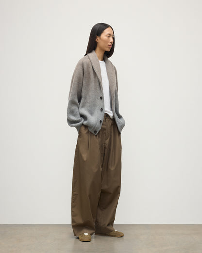 FEMALE MODEL WEARING JOHNSTONS OF ELGIN PIONEER SHAWL CARDIGAN GREY 100% CASHMERE WITH BROWN WIDE LEG CHINOS, WHITE T-SHIRT & TRAINERS UAA05750Q25948