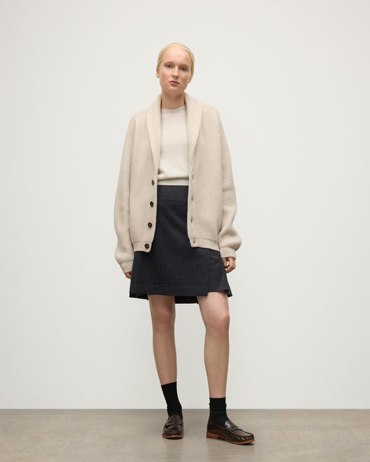 FEMALE MODEL WEARING JOHNSTONS O F ELGIN PIONEER SHAWL CARDIGAN NATURAL 100% CASHMERE WITH MATCHING CASHMERE SWEATER AND CHARCOAL SHORT LE KILT SKIRT UAA05750Q26191