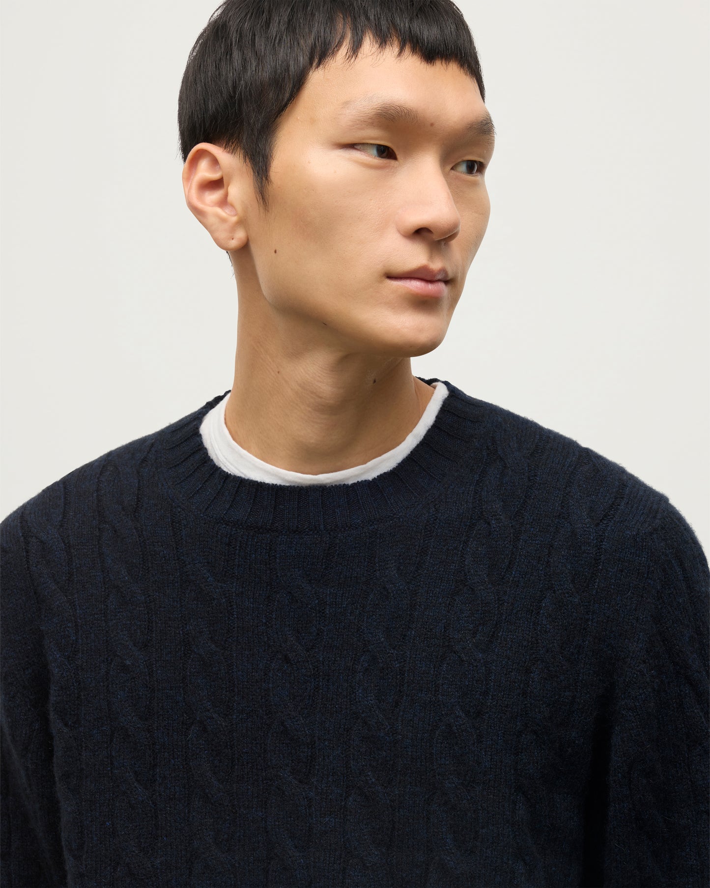 JOHNSTONS OF ELGIN MENS CALDER CREW SWEATER DARK BLUE 100% CASHMERE OVER A WHITE T-SHIRT WITH BROWN TROUSERS KAA05754HD7347