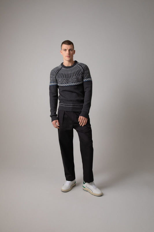 Johnstons of Elgin’s Men's Fairisle Yoke Cashmere Jumper in Charcoal grey on model wearing black trousers on a grey background KAB05108Q23714