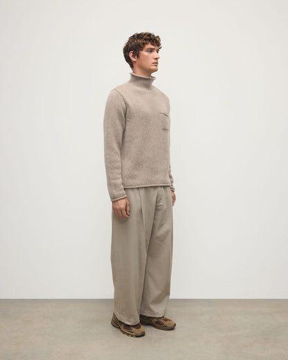 Model wearing Johnstons of Elgin AW25 Men's Knitwear Ash Brown Cashmere Turtleneck Jumper Side KAB05484HB4334