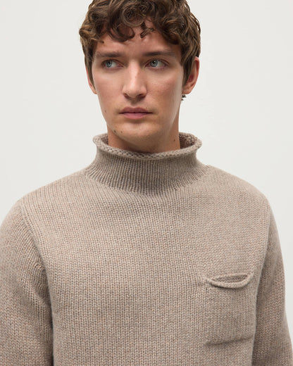 Model wearing Johnstons of Elgin AW25 Men's Knitwear Ash Brown Cashmere Turtleneck Jumper details KAB05484HB4334