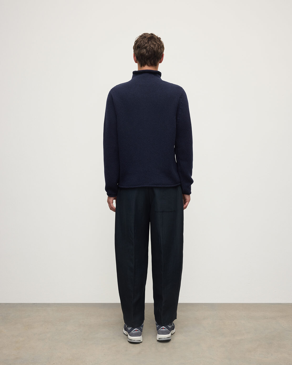 Back view of a model wearing Johnstons of Elgin  Men's Knitwear Dark Navy Navy Cashmere Turtleneck Jumper KAB05484SD7666