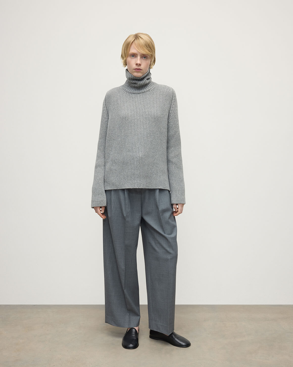 Model wears Johnstons of Elgin AW25 Women's Knitwear Light Grey Roll-Collar Grey Cashmere Jumper Front View KAB05492HA0308