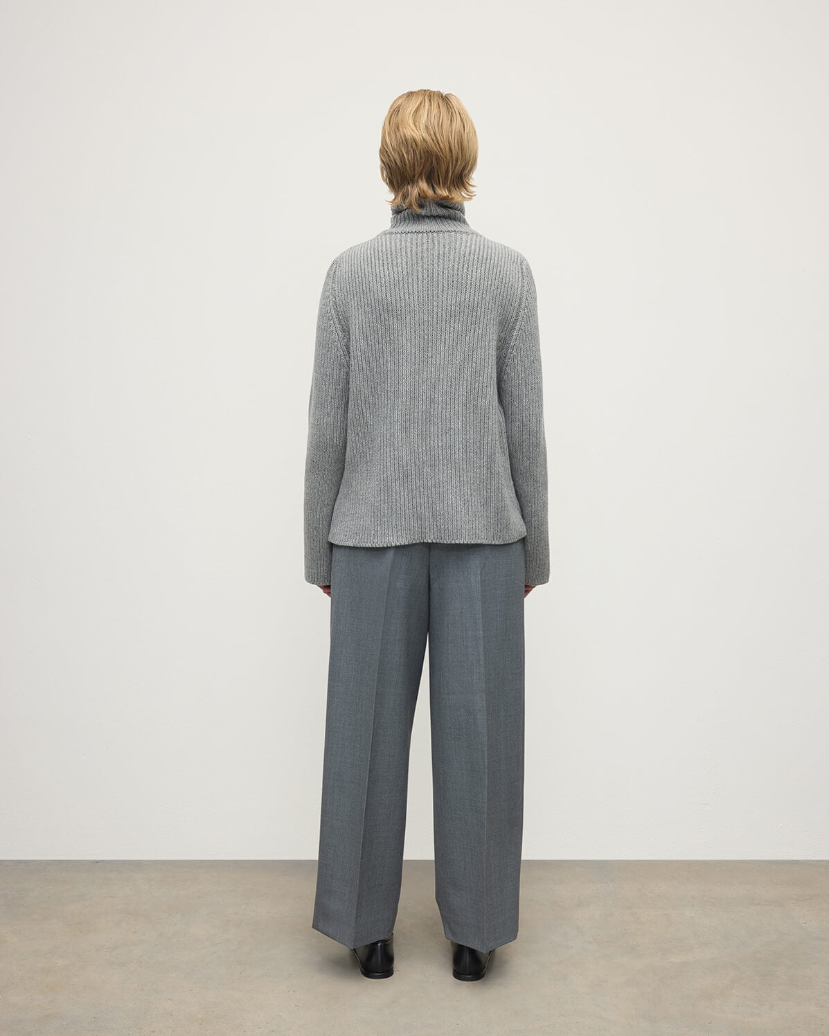 Model wears Johnstons of Elgin AW25 Women's Knitwear Light Grey Roll-Collar Grey Cashmere Jumper Back View KAB05492HA0308