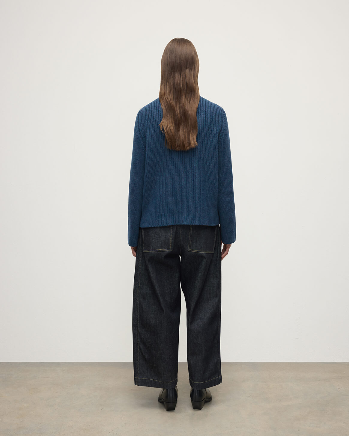 Model wears Johnstons of Elgin AW25 Women's Knitwear Heather Navy Roll-Collar Navy Cashmere Jumper Back View KAB05492HD7321