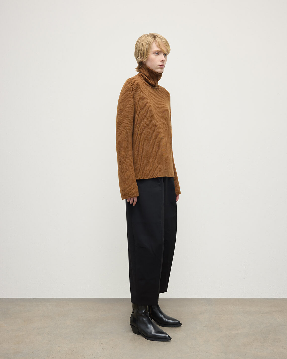 Model wearing Johnstons of Elgin AW25 Women's Knitwear Dark Camel Roll-Collar Camel Cashmere Jumper Side View KAB05492SB4620