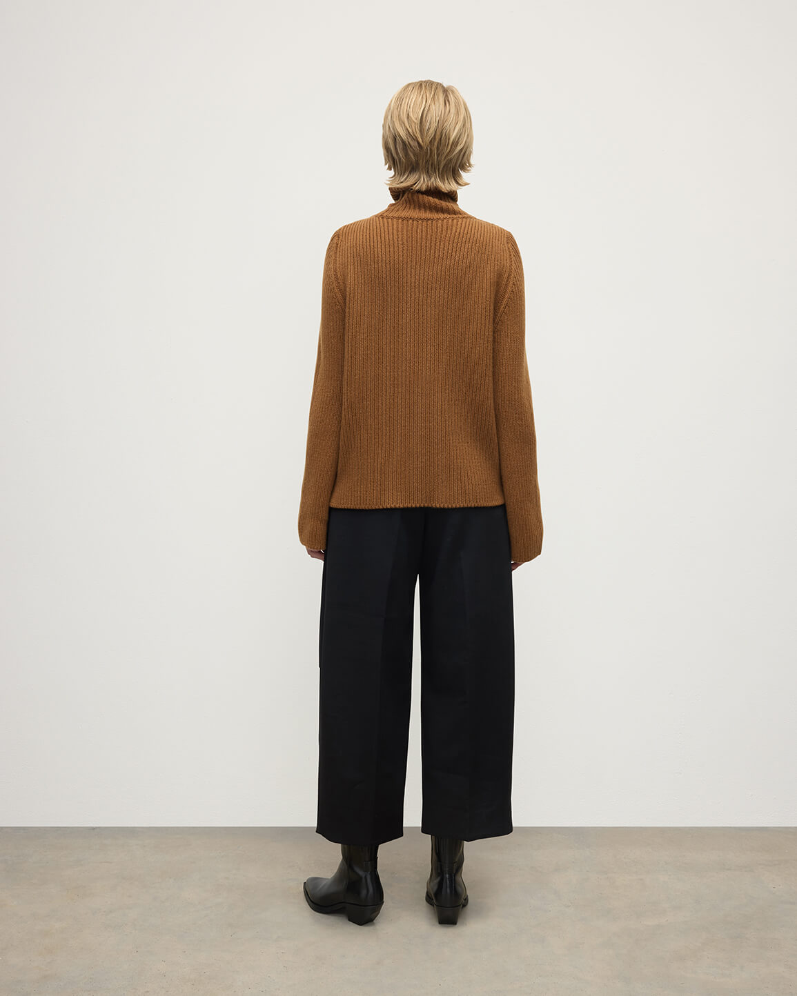 Model wearing Johnstons of Elgin AW25 Women's Knitwear Dark Camel Roll-Collar Camel Cashmere Jumper Back View KAB05492SB4620