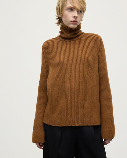 Model wearing Johnstons of Elgin AW25 Women's Knitwear Dark Camel Roll-Collar Camel Cashmere Jumper details KAB05492SB4620