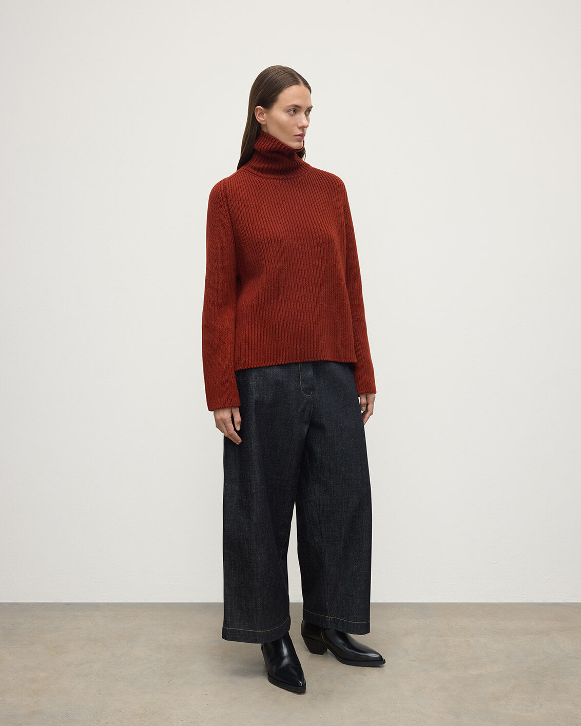 Model wears Johnstons of Elgin AW25 Women's Knitwear Oxblood Roll-Collar Red Cashmere Jumper Side View KAB05492SG4463