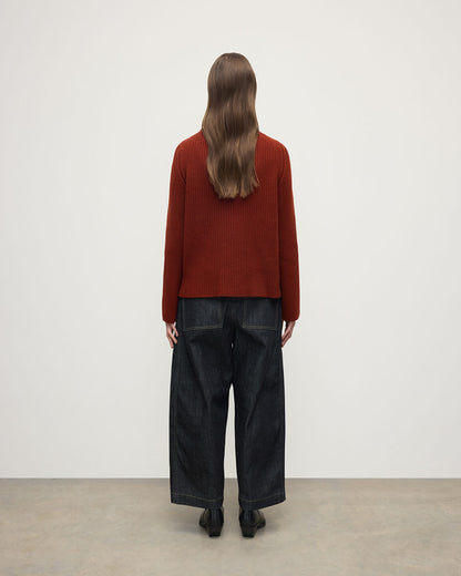 Model wears Johnstons of Elgin AW25 Women's Knitwear Oxblood Roll-Collar Red Cashmere Jumper Back View KAB05492SG4463