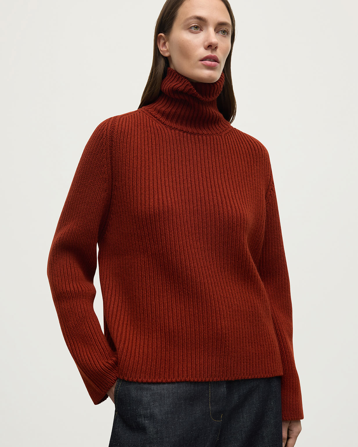 Model wears Johnstons of Elgin AW25 Women's Knitwear Oxblood Roll-Collar Red Cashmere Jumper Close Up KAB05492SG4463
