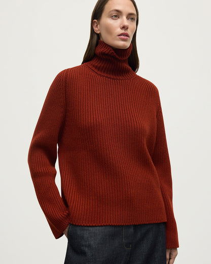 Model wears Johnstons of Elgin AW25 Women's Knitwear Oxblood Roll-Collar Red Cashmere Jumper Close Up KAB05492SG4463