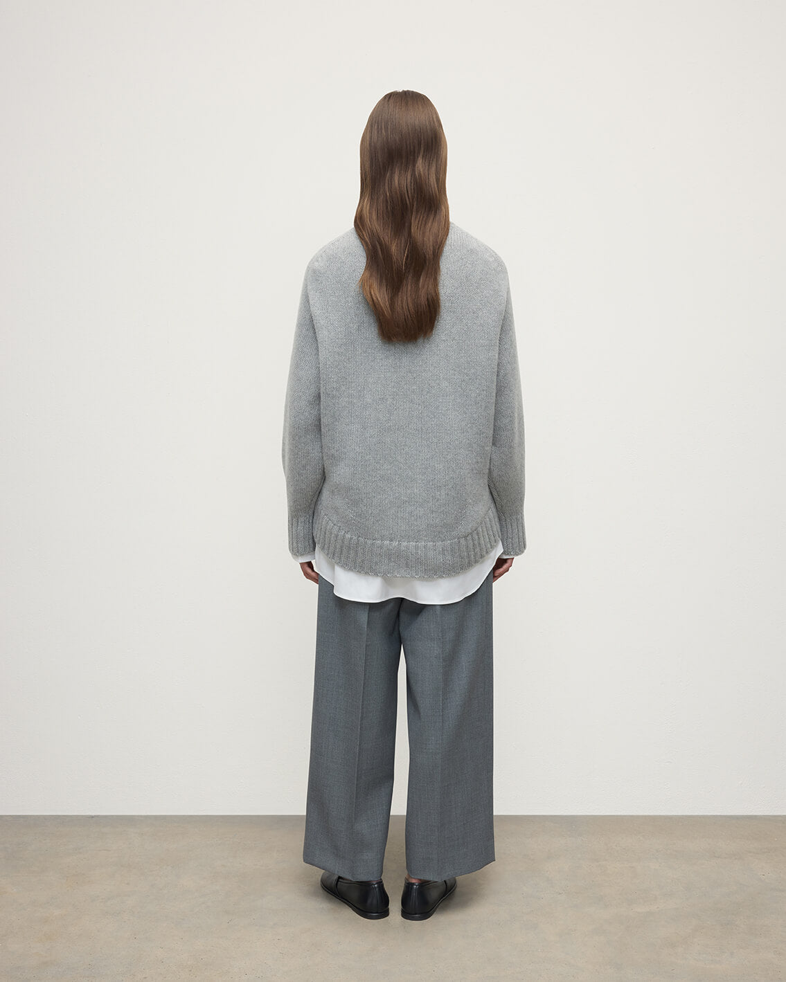 Model wearing Johnstons of Elgin AW25 Women's Knitwear Light Grey Relaxed Grey Cashmere Jumper Back View KAB05562HA0308