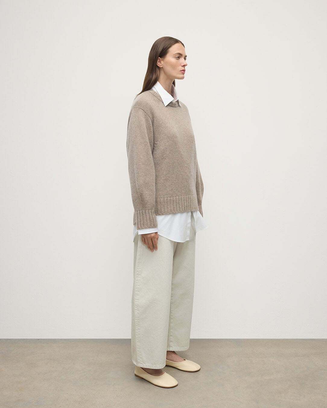 Model wears Johnstons of Elgin AW25 Women's Knitwear Ash Relaxed Brown Cashmere Jumper Side View KAB05562HB4334