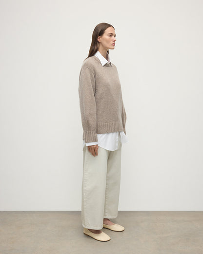 Model wears Johnstons of Elgin AW25 Women's Knitwear Ash Relaxed Brown Cashmere Jumper Side View KAB05562HB4334