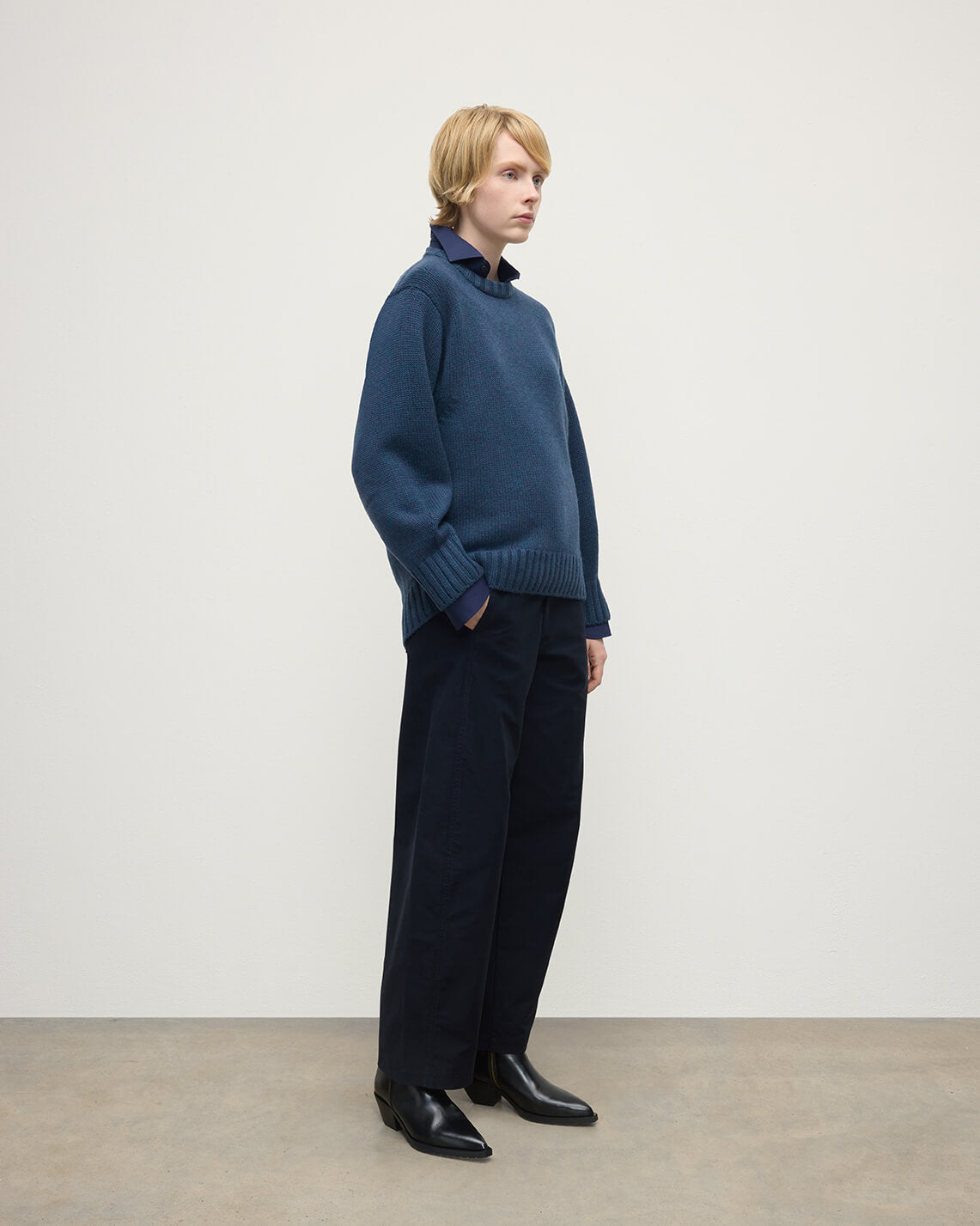 Model wearing Johnstons of Elgin AW25 Women's Knitwear Heather Navy Relaxed Navy Cashmere Jumper Side View KAB05562HD7321