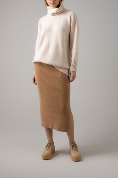Johnstons of Elgin Ribbed Tube Cashmere Skirt in Camel worn with matching Slim Fit Cashmere Sweater on a grey background KBP00923HB4315
