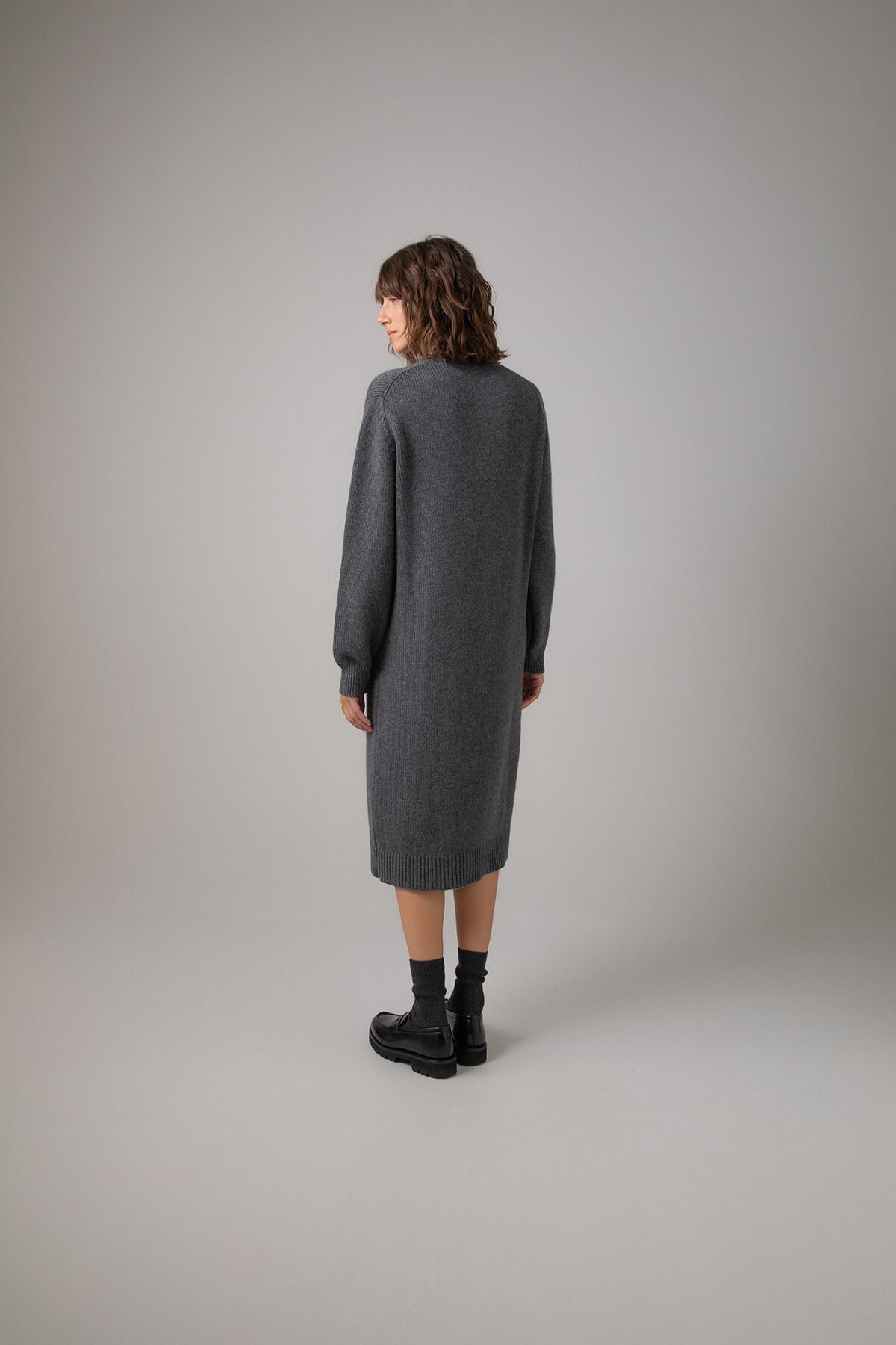 Back view of Johnstons of Elgin Crew Neck Cashmere Jumper Dress in Mid Grey on a grey background KAC05045HA4181