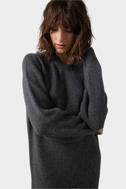 Model wearing Johnstons of Elgin Crew Neck Cashmere Jumper Dress in Mid Grey on a grey background KAC05045HA4181