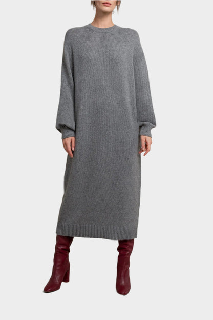 Model wearing Johnstons of Elgin Women’s Cashmere Sweater Dress in Granite a grey background KAC05045HA5931