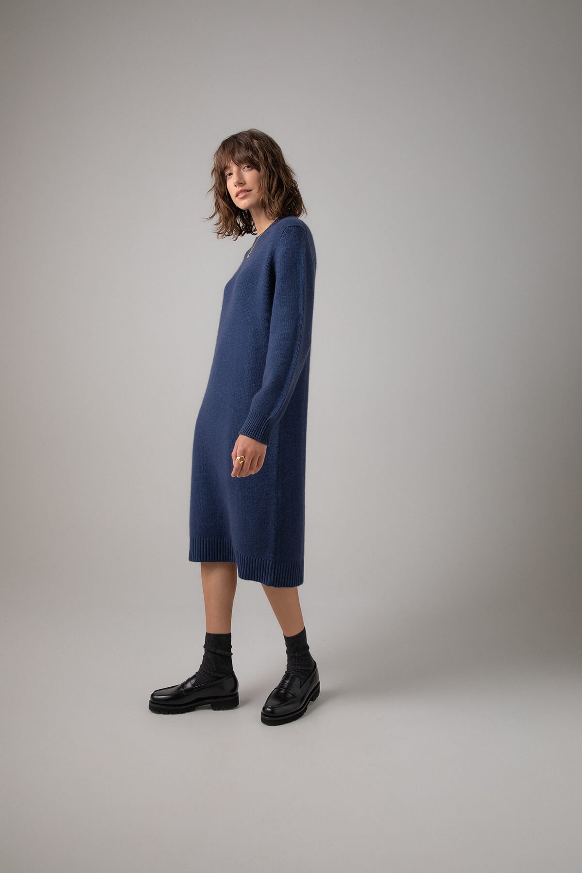 Side view of Johnstons of Elgin Crew Neck Cashmere Jumper Dress in Ocean a grey background KAC05045HD7244