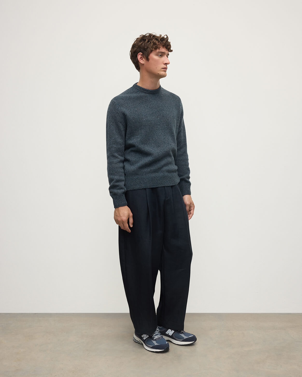 Side view of a model wearing Johnstons of Elgin AW25 Men's Knitwear Storm Donegal Donegal Cashmere Marl Jumper KAC05287006336