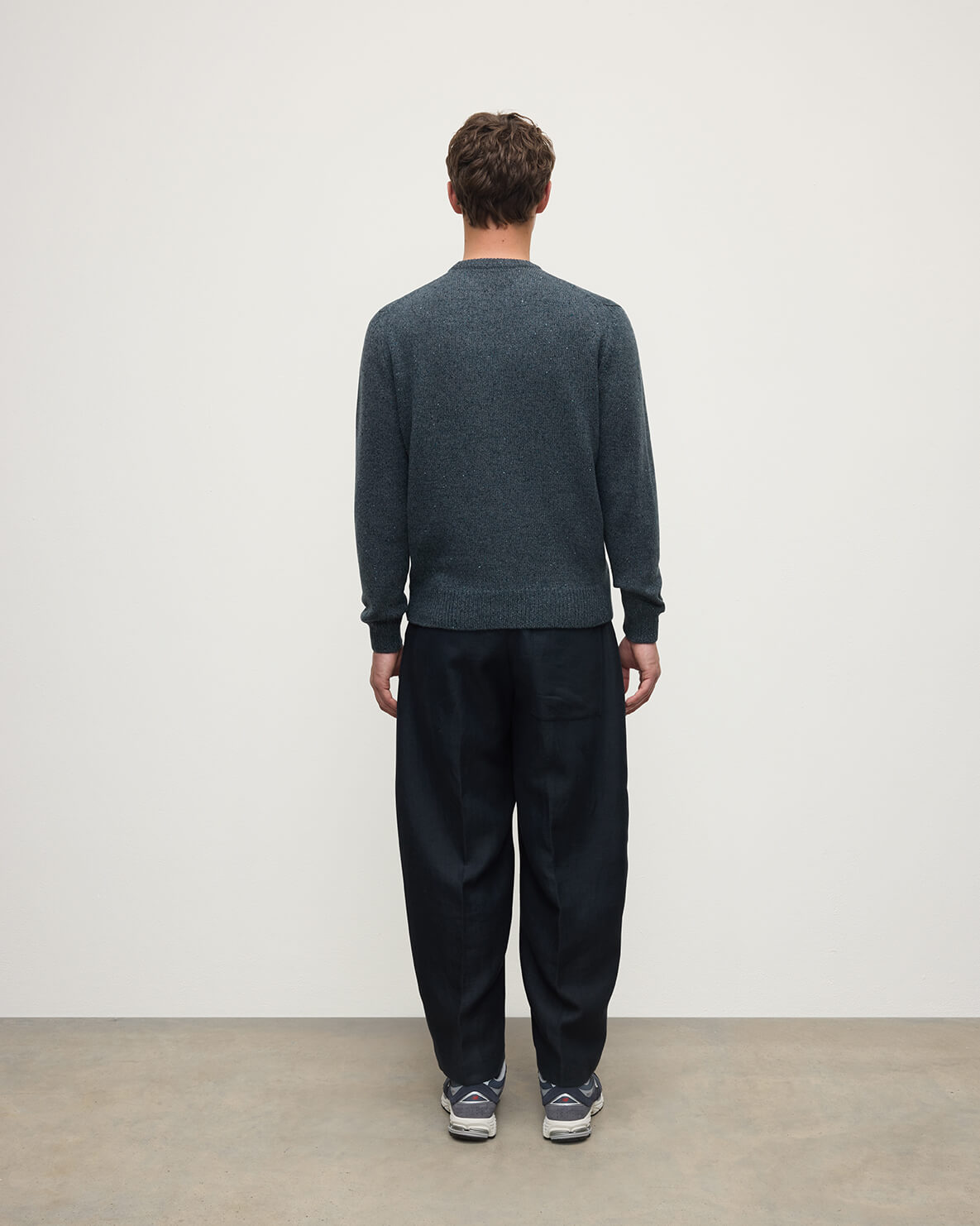 Back view of a model wearing Johnstons of Elgin AW25 Men's Knitwear Storm Donegal Donegal Cashmere Marl Jumper KAC05287006336