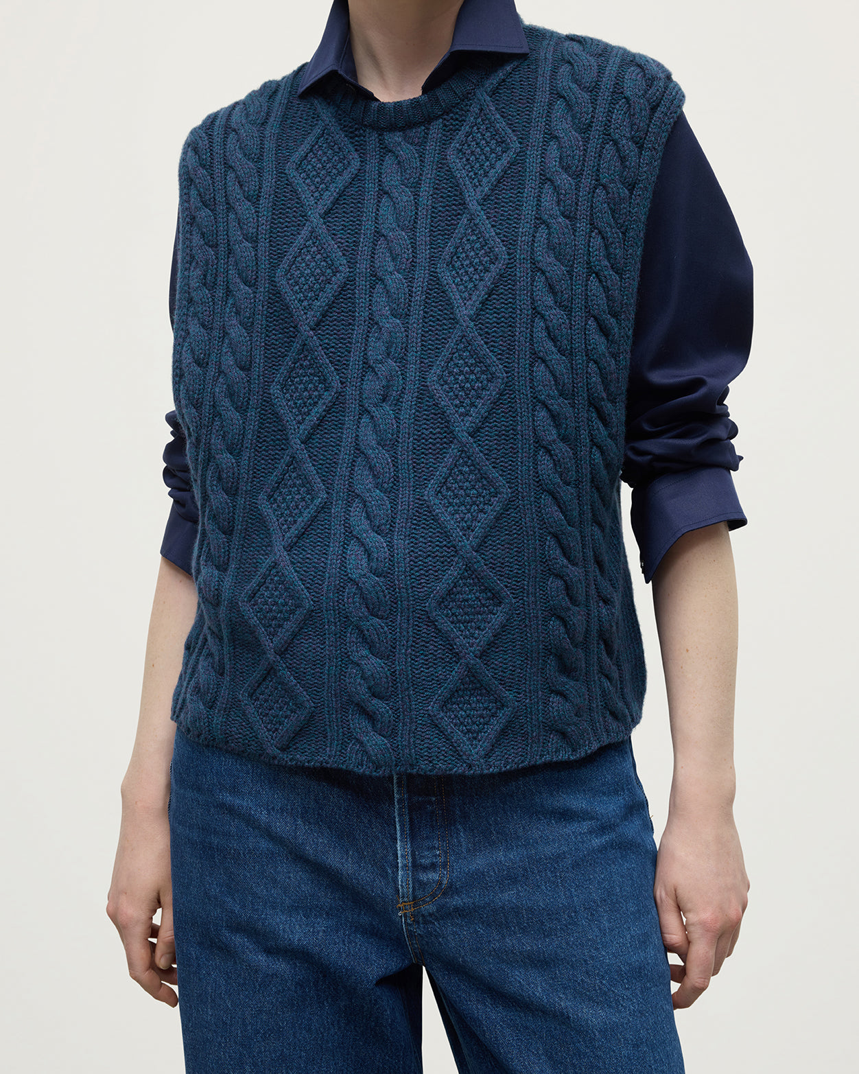 Model wears Johnstons of Elgin AW25 Women's Knitwear Heather Navy Aran Cable Navy Cashmere Tank Details KAC05321HD7321