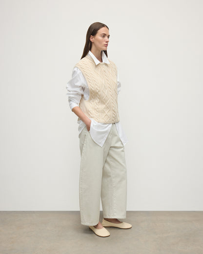 Model wears Johnstons of Elgin AW25 Women's Knitwear Champagne Aran Cable Cream Cashmere Tank Side View KAC05321SA0502