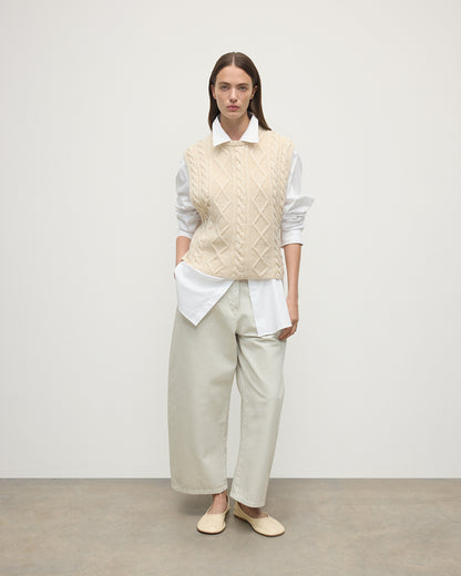 Model wears Johnstons of Elgin AW25 Women's Knitwear Champagne Aran Cable Cream Cashmere Tank Front View KAC05321SA0502