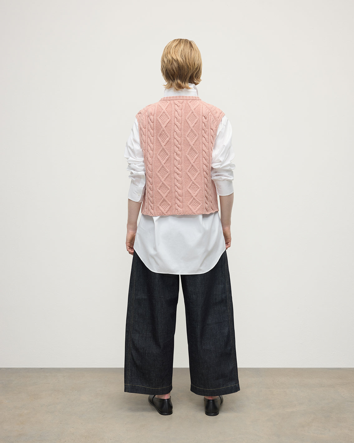 model wearing Johnstons of Elgin AW25 Women's Knitwear Nude Aran Cable Pink Cashmere Tank Back View KAC05321SE0740