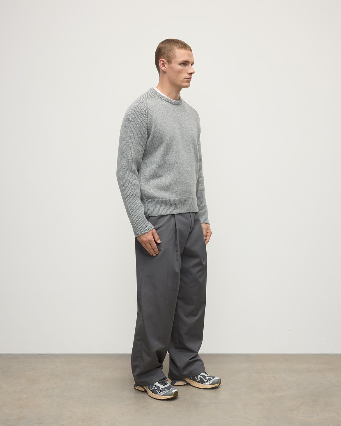 Side view of model wearing Johnstons of Elgin AW25 Men's Knitwear Light Grey Ribbed Grey Cashmere Jumper KAC05540HA0308