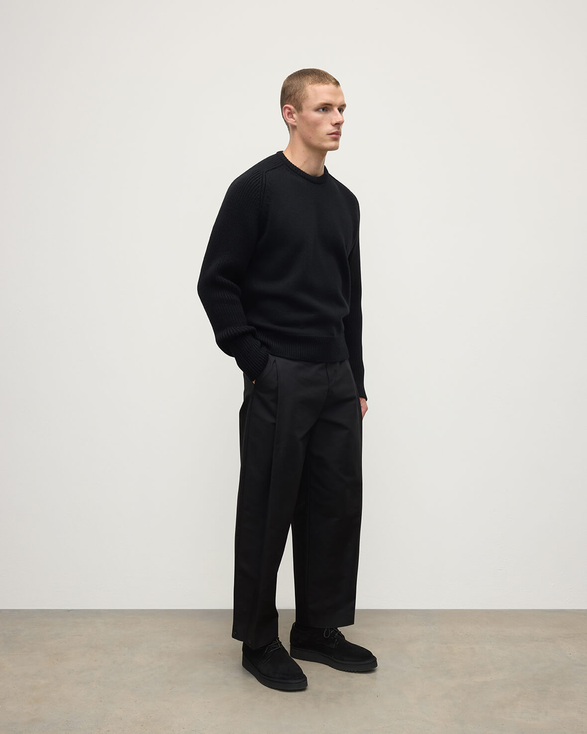 Side View model wearing Johnstons of Elgin AW25 Men's Knitwear Black Ribbed Black Cashmere Jumper KAC05540SA7210