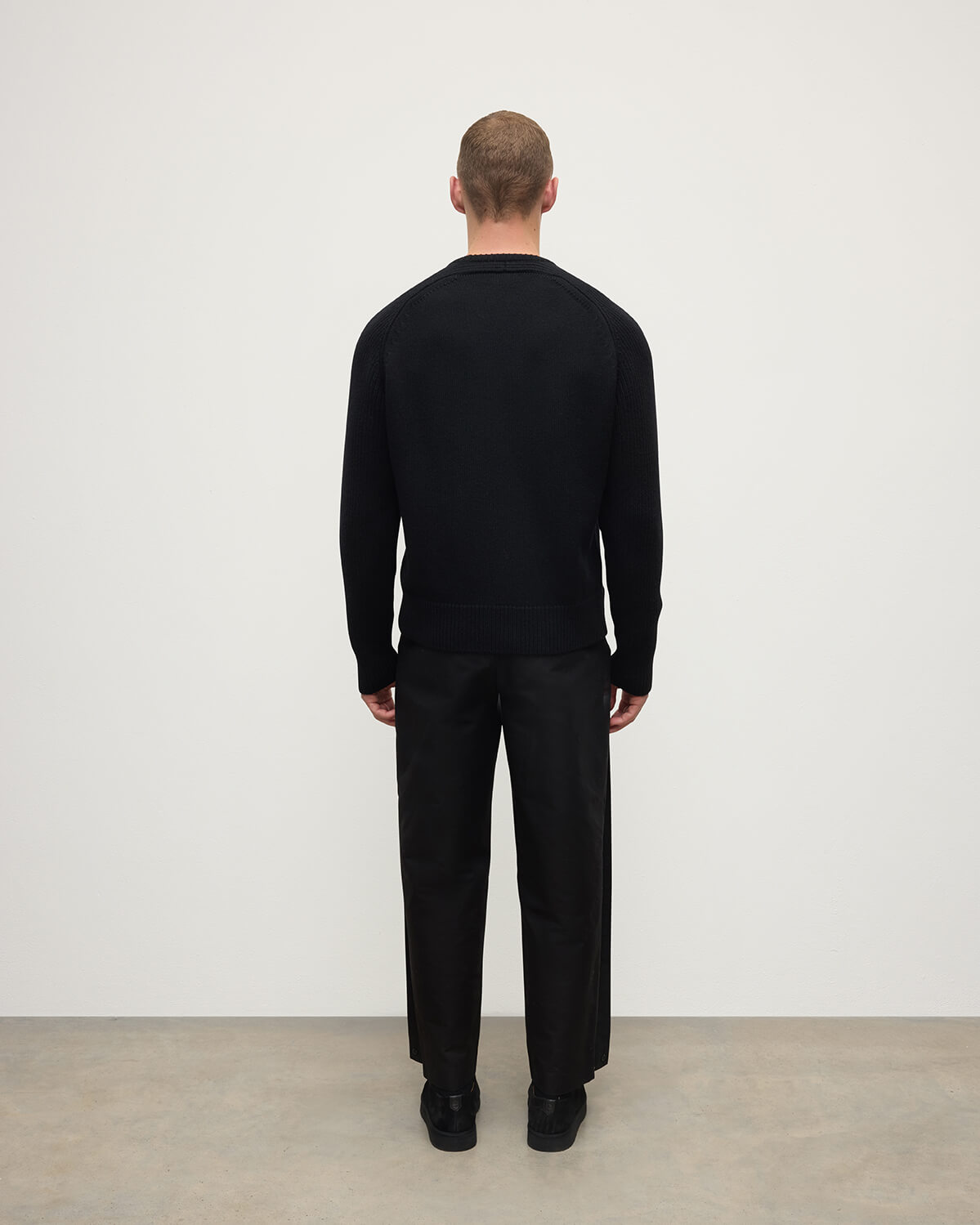 Back View model wearing Johnstons of Elgin AW25 Men's Knitwear Black Ribbed Black Cashmere Jumper KAC05540SA7210