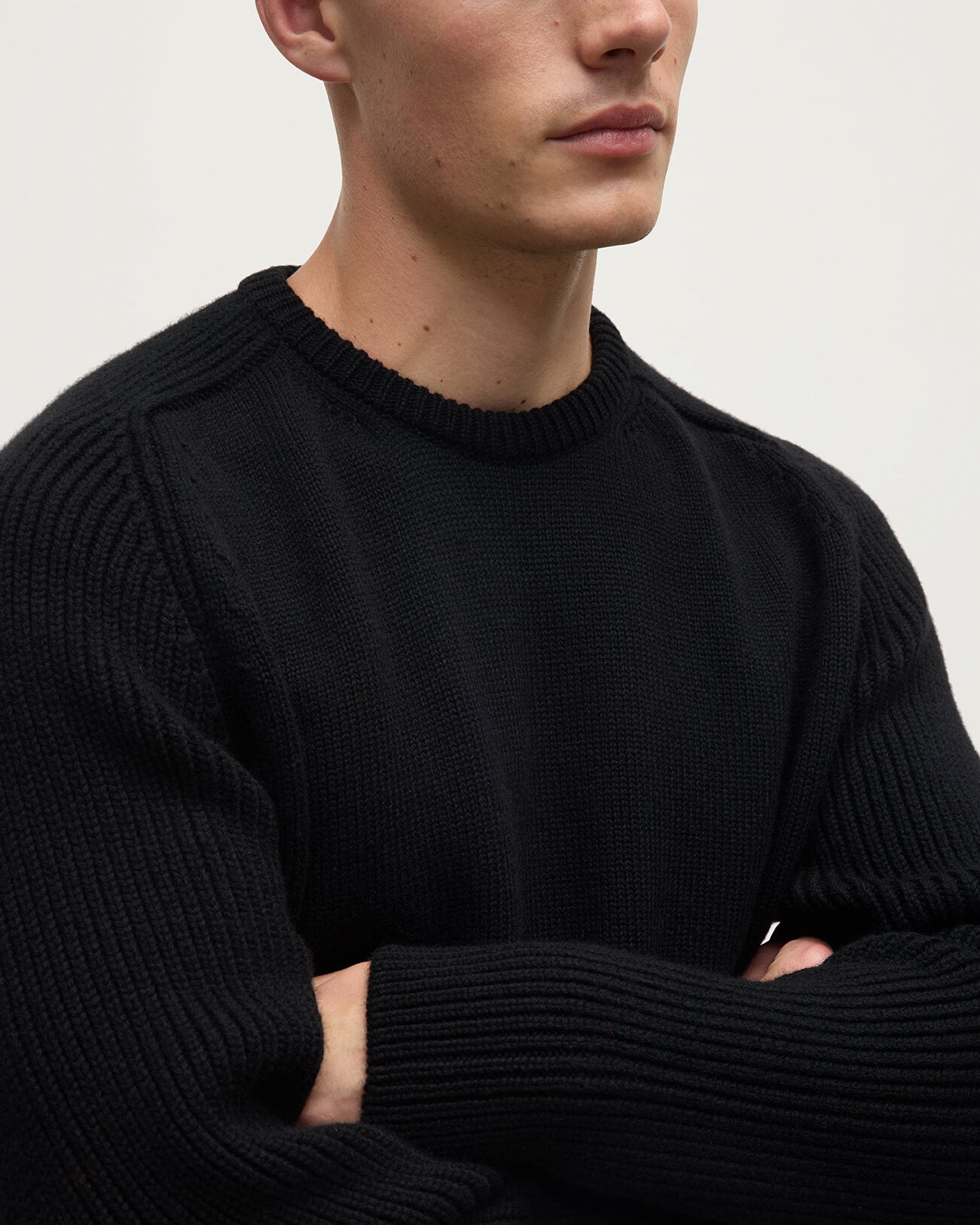Close Up model wearing Johnstons of Elgin AW25 Men's Knitwear Black Ribbed Black Cashmere Jumper KAC05540SA7210
