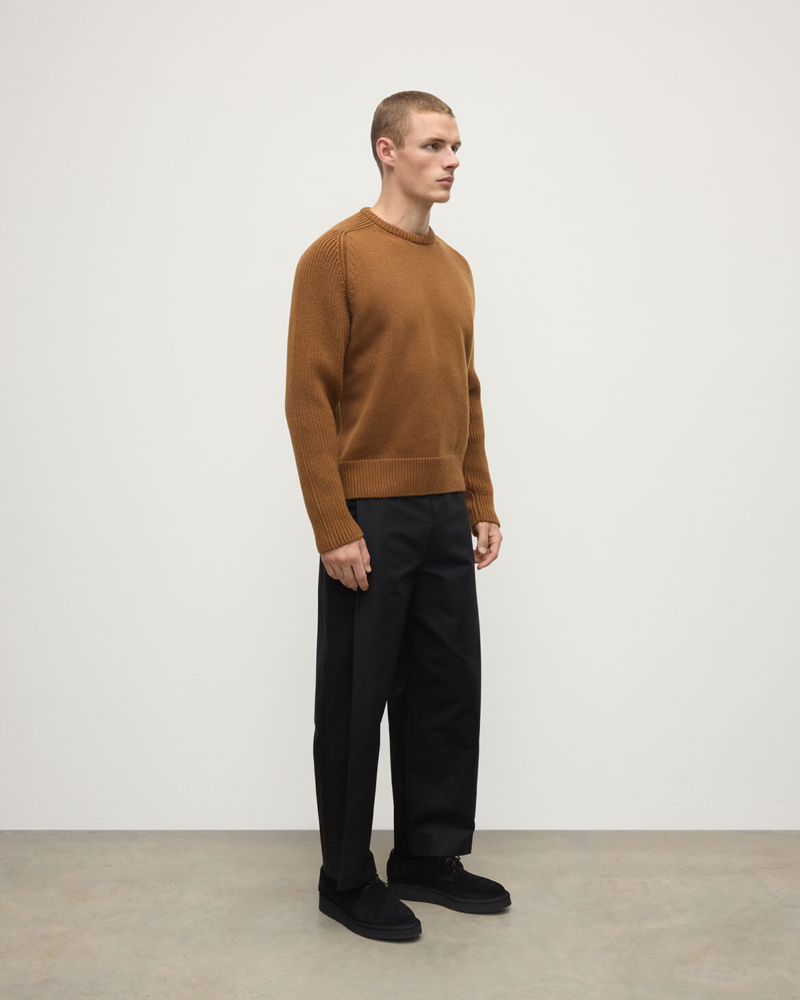 Side view of model wearing Johnstons of Elgin AW25 Men's Knitwear Dark Camel Ribbed Camel Cashmere Jumper KAC05540SB4620