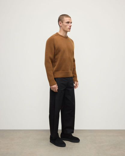 Side view of model wearing Johnstons of Elgin AW25 Men's Knitwear Dark Camel Ribbed Camel Cashmere Jumper KAC05540SB4620