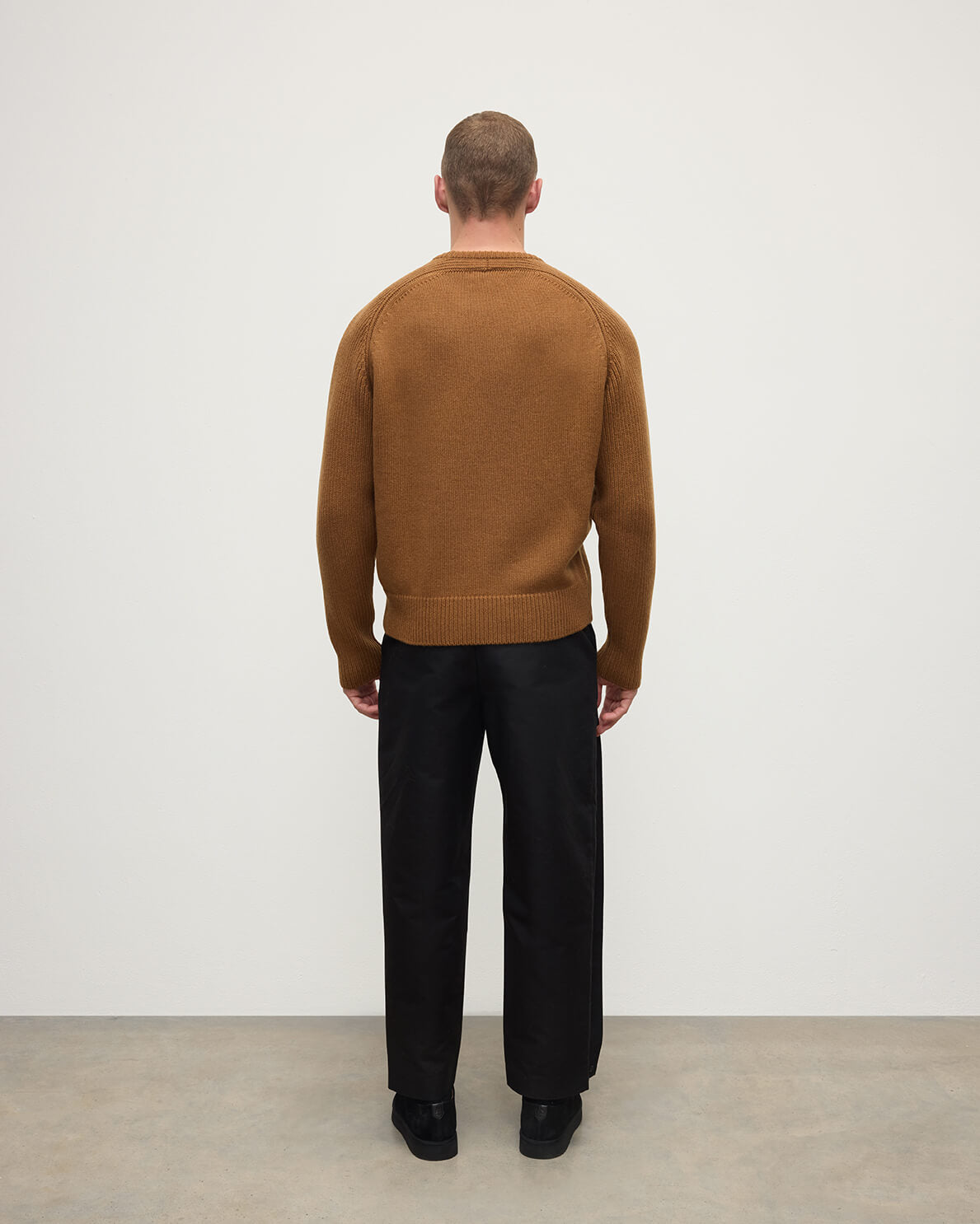 back view of model wearing Johnstons of Elgin AW25 Men's Knitwear Dark Camel Ribbed Camel Cashmere Jumper KAC05540SB4620