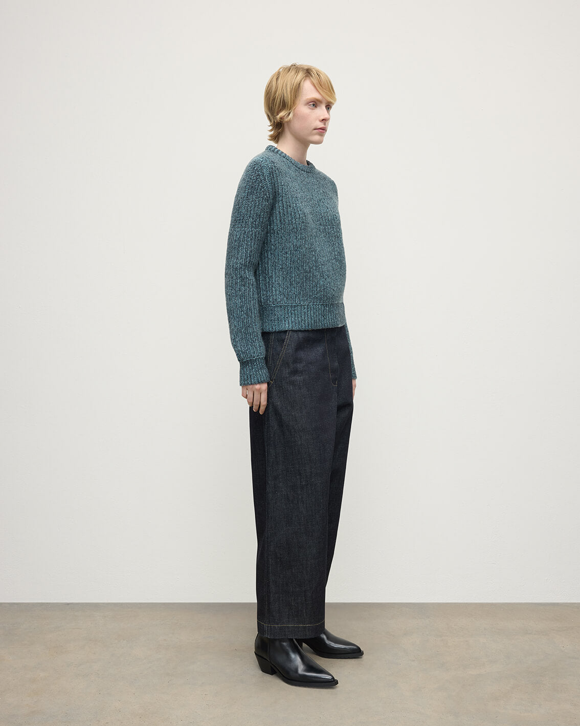 Model wearing Johnstons of Elgin AW25 Women's Knitwear Storm Donegal & Seascape High Neck Donegal Cashmere Blue Jumper Side View KAC05590Q25392