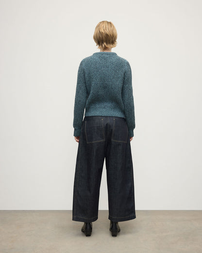 Model wearing Johnstons of Elgin AW25 Women's Knitwear Storm Donegal & Seascape High Neck Donegal Cashmere Blue Jumper Back View KAC05590Q25392