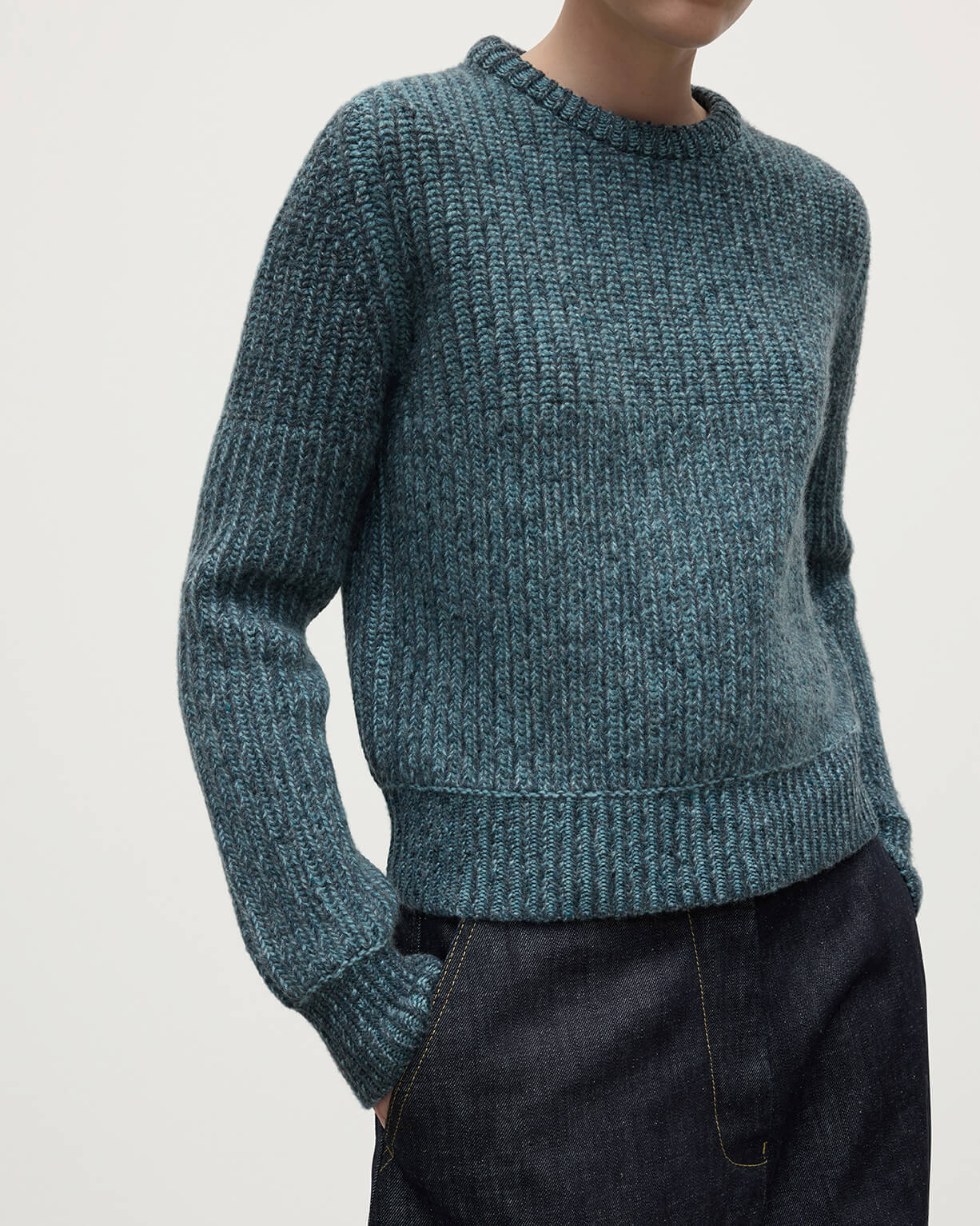 Model wearing Johnstons of Elgin AW25 Women's Knitwear Storm Donegal & Seascape High Neck Donegal Cashmere Blue Jumper Details  KAC05590Q25392