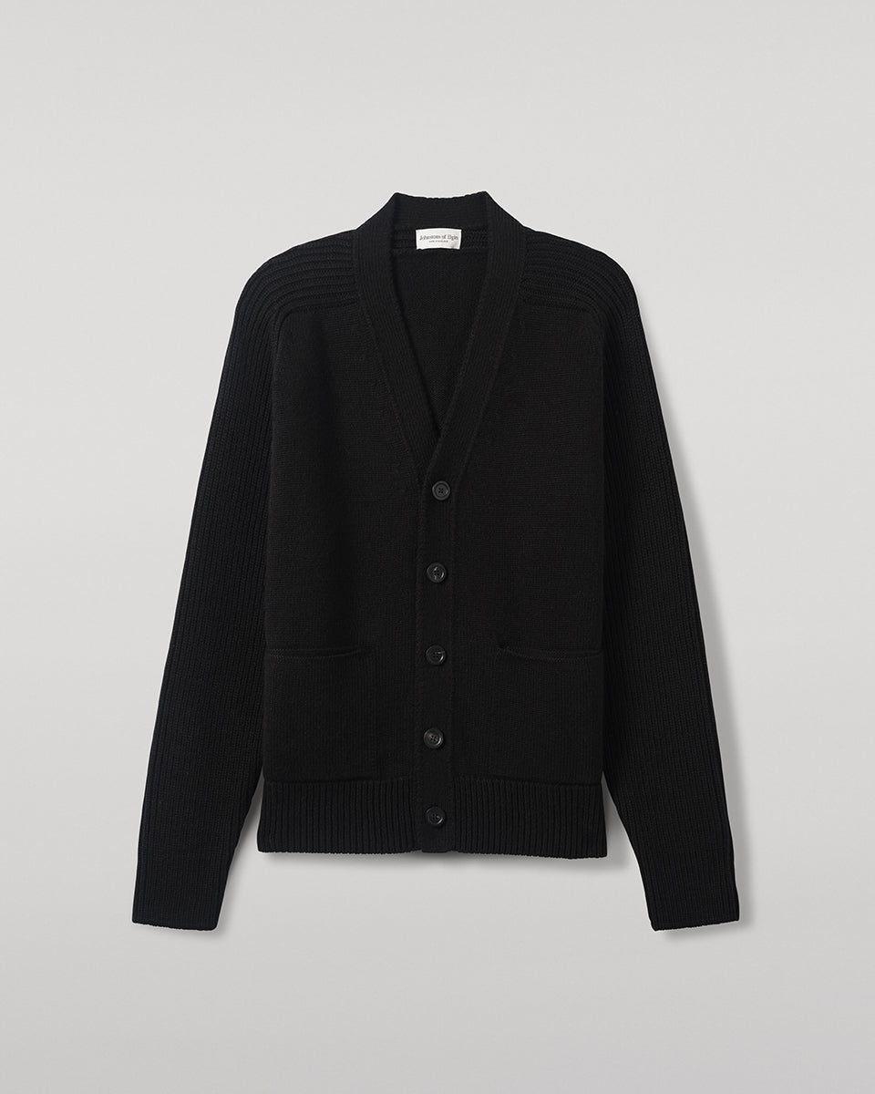 Johnstons of Elgin AW25 Men's Knitwear Black Ribbed Cashmere Black Cardigan worn over a black t-shirt, showing button details  KAC05601SA7210