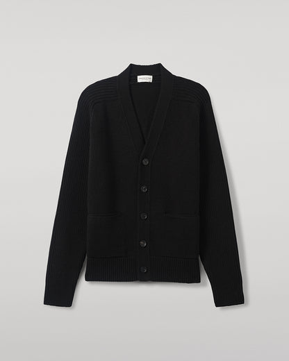 Johnstons of Elgin AW25 Men's Knitwear Black Ribbed Cashmere Black Cardigan worn over a black t-shirt, showing button details  KAC05601SA7210